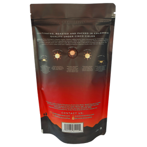 Back view of a stand-up pouch package for Cinco Cielos Coffee, featuring a dark brown top section, a red-to-orange gradient middle, black mountain silhouette at the bottom, and printed product information including origin text, sun icons, and a barcode.